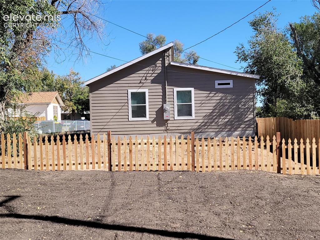 Image 40 of 41: Exterior featuring horizontal siding, a shed roofline, and a wood picket fe