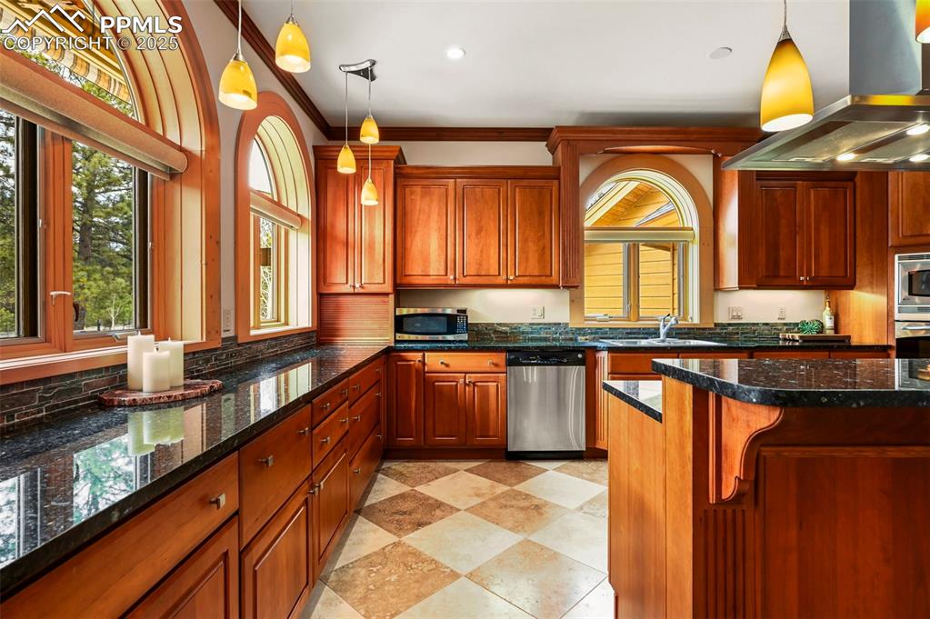 Image 12 of 50: Kitchen with pendant light fixtures