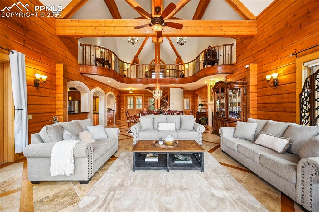 Image 13 of 50: Living room with vaulted ceilings