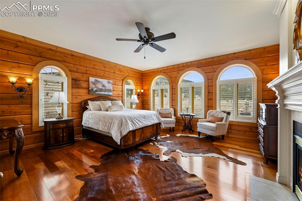 Image 19 of 50: Primary Bedroom featuring a fireplace