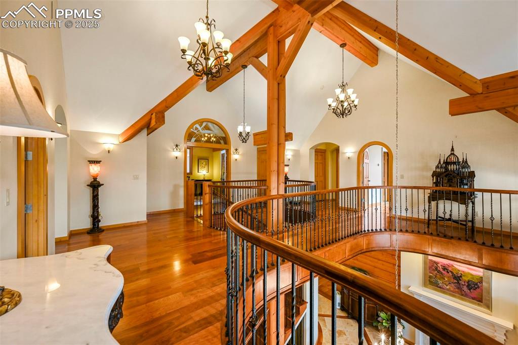 Image 24 of 50: Upstairs landing/hall with vaulted ceilings/beams