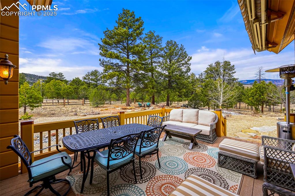 Image 39 of 50: Dear Wooden deck featuring an outdoor living space and outdoor dining area