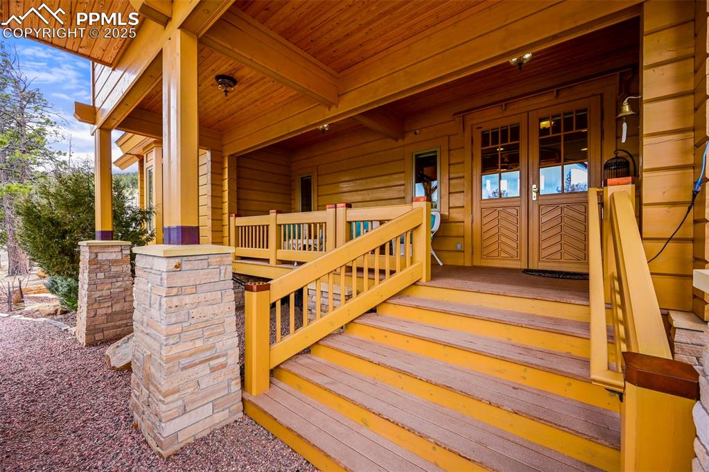 Image 5 of 50: Doorway to property with covered porch feature 