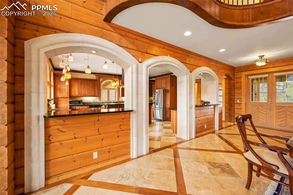 Image 8 of 50: Foyer, custom arches and kitchen entry