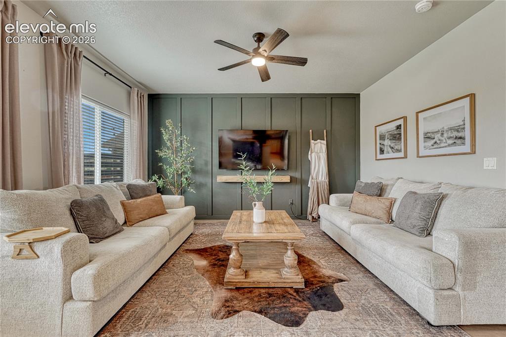 Image 2 of 50: Recessed lighting, ceiling fan with integrated light, a feature wall with v