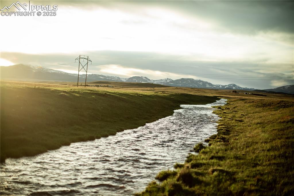 Caption: Water view featuring mountains and rural landscape