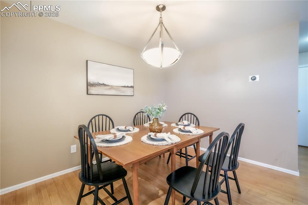 Image 15 of 47: Dining room featuring light wood-type flooring and baseboards