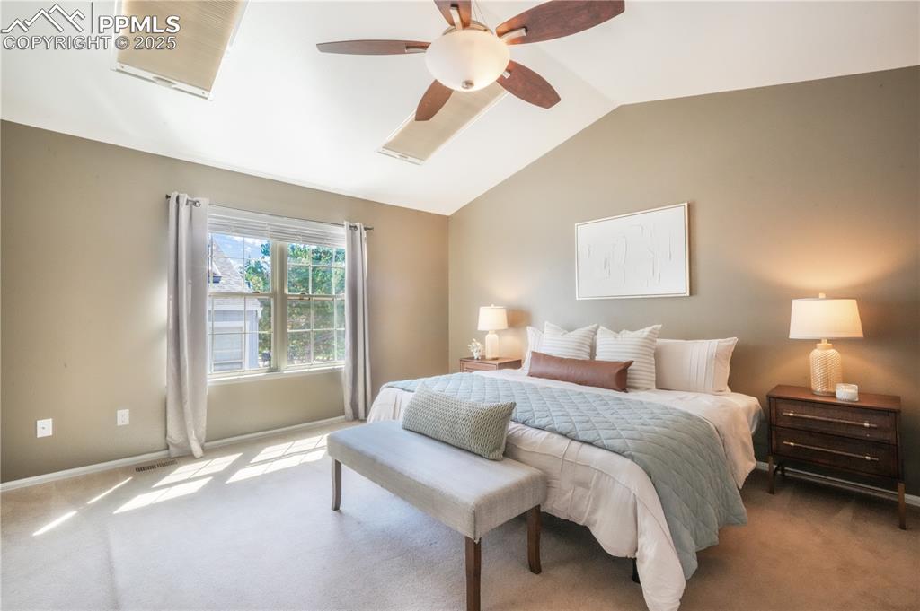 Image 24 of 47: Bedroom with carpet floors, lofted ceiling, and a ceiling fan