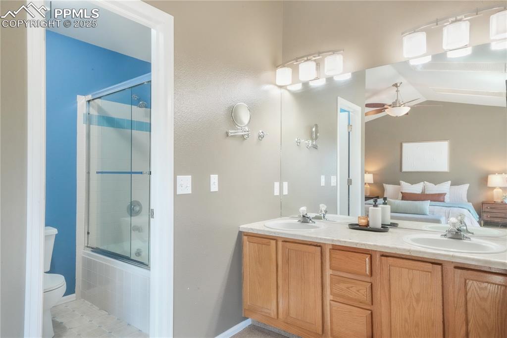 Image 27 of 47: Ensuite bathroom featuring shower / bath combination with glass door, doubl