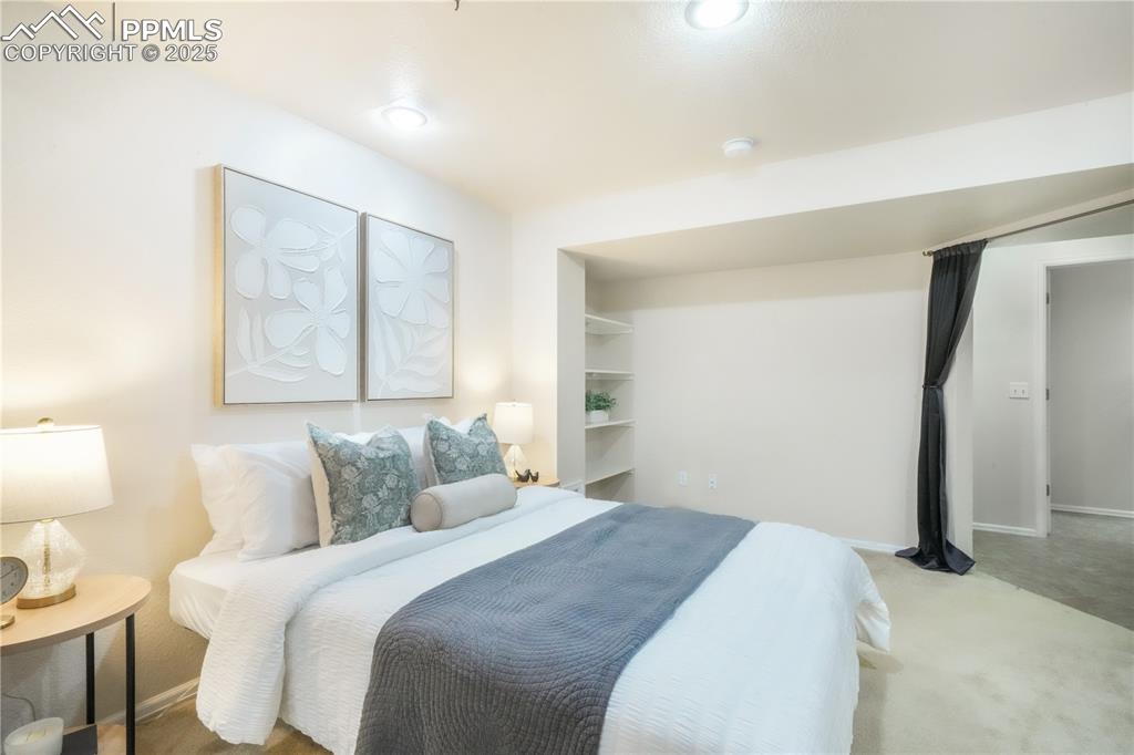 Image 33 of 47: Bedroom with carpet floors and baseboards