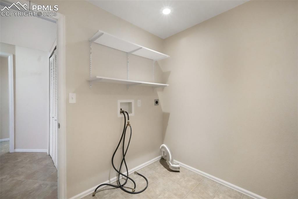 Image 38 of 47: Laundry room with hookup for a washing machine and electric dryer hookup