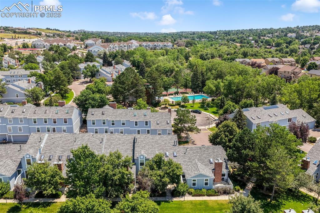 Image 41 of 47: Aerial perspective of suburban area featuring a pool area