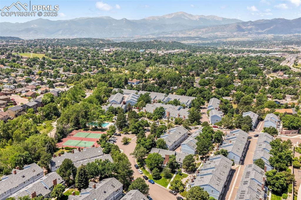 Image 46 of 47: Aerial perspective of suburban area with a mountain backdrop