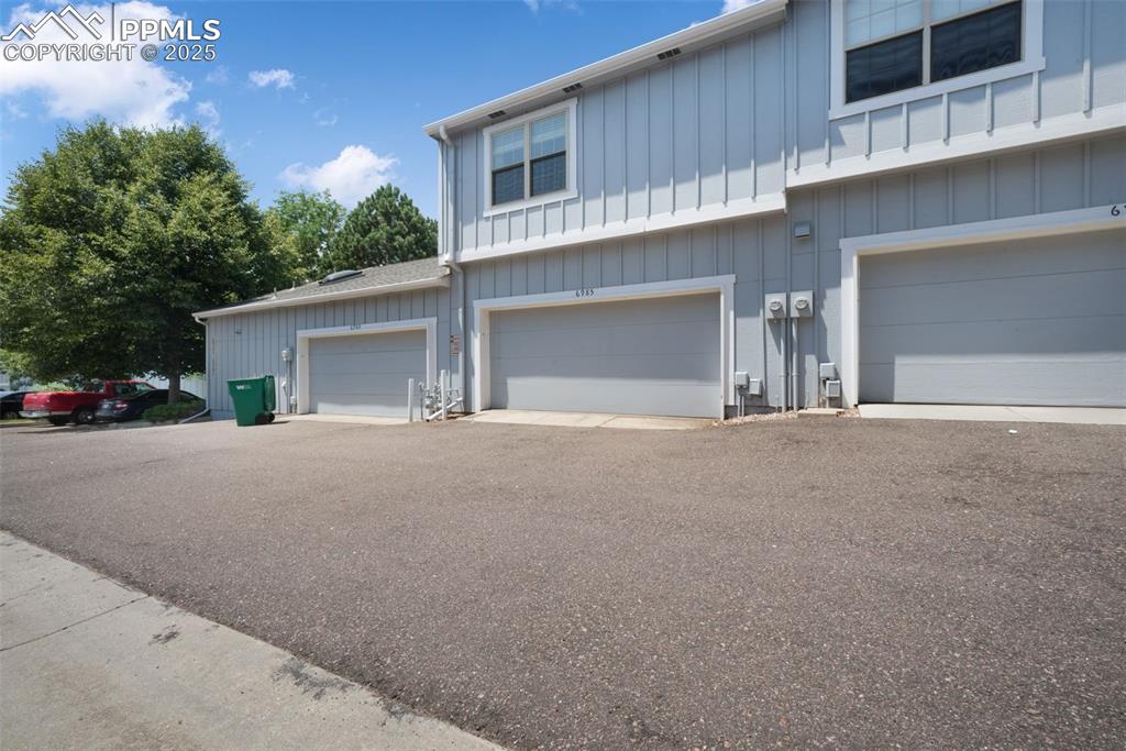 Image 8 of 47: View of front facade with an attached garage and board and batten siding