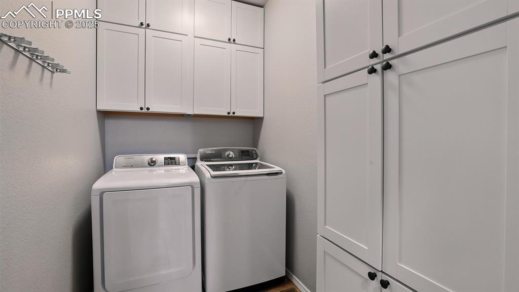 Image 18 of 50: Laundry Room with built-in cabinets.
