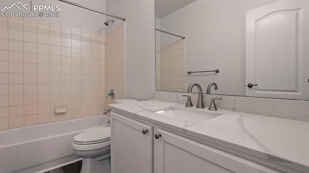 Image 42 of 50: Basement Bathroom with vanity, mirror, and tiled tub/shower.