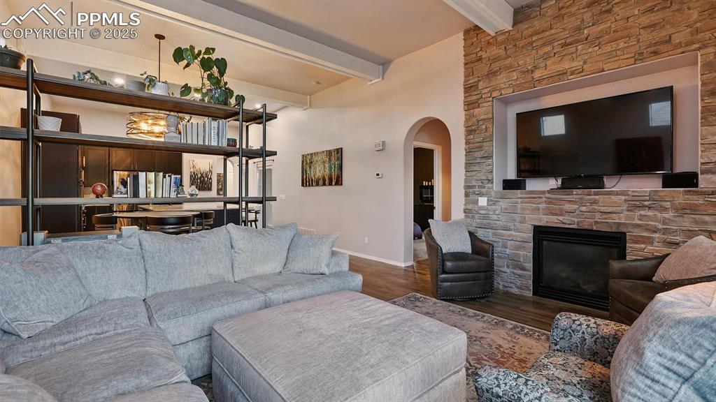 Image 9 of 50: High beamed ceilings and gorgeous gas log fireplace with stacked stone surr