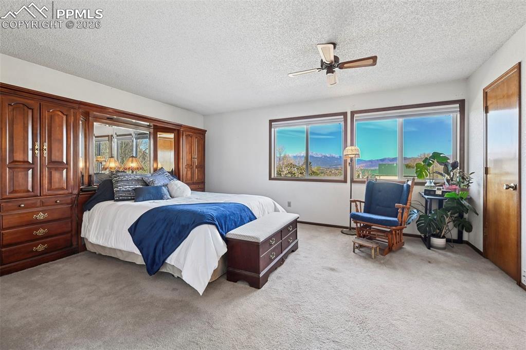 Image 14 of 45: Large primary bedroom with unobstructed views of Pikes Peak.
