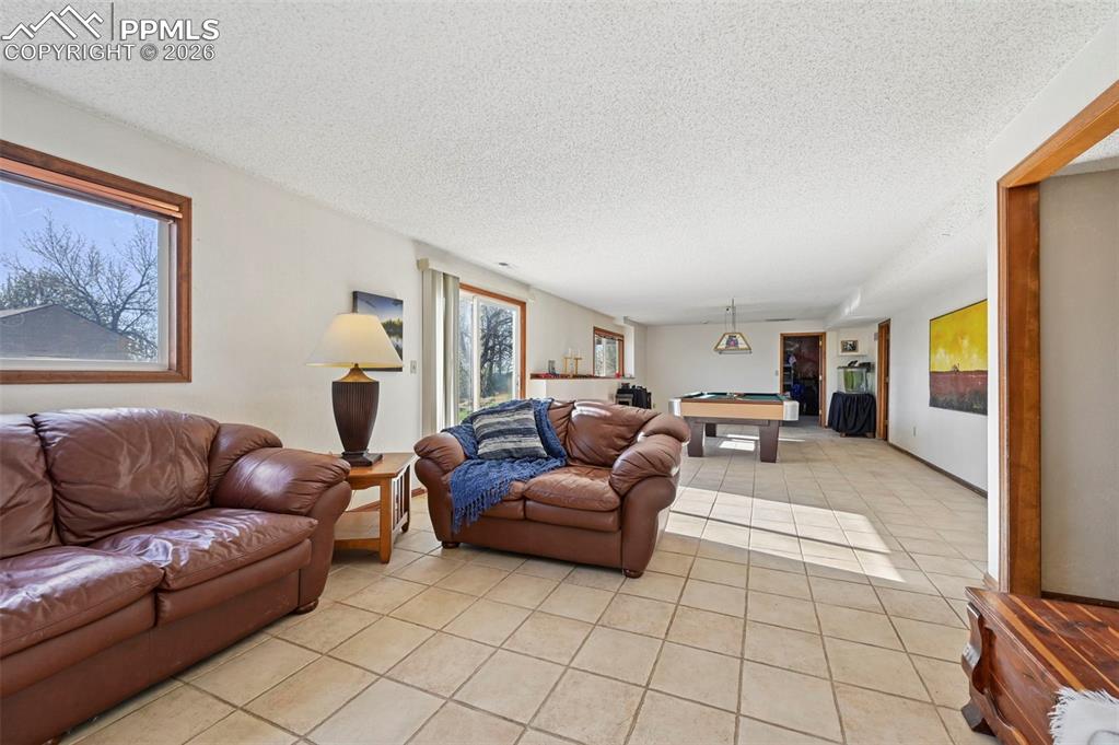 Image 24 of 45: large open space in basement. Great for gathering, playing or just hanging 