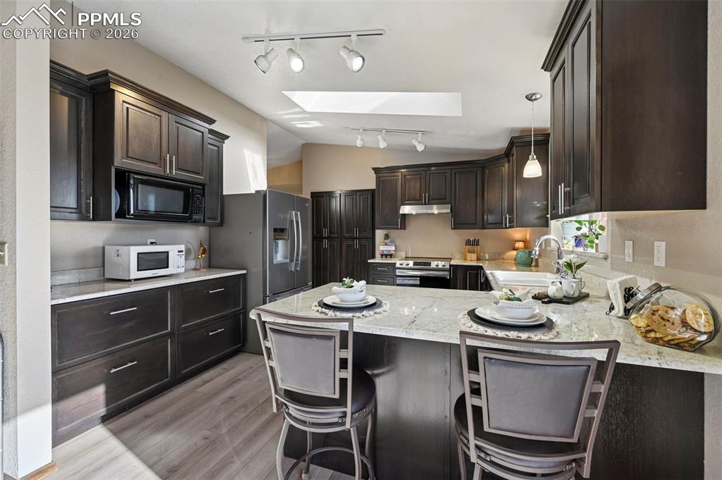 Image 4 of 45: Gourmet kitchen with custom cabinets, solid stone counters and large pantry