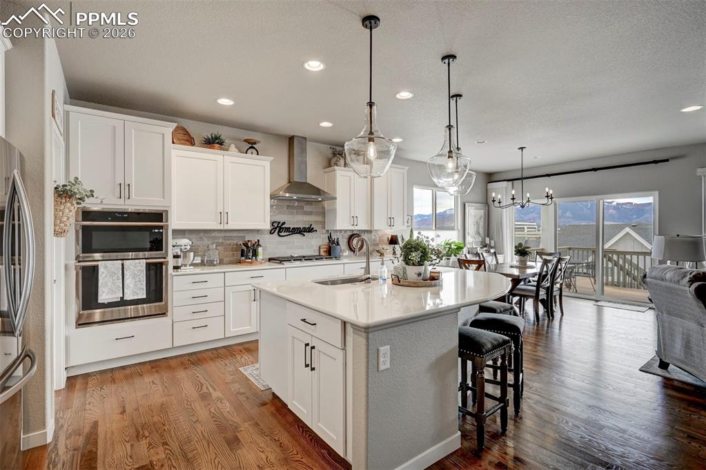Image 14 of 41: Kitchen with an island with sink, a kitchen breakfast bar, stainless steel 