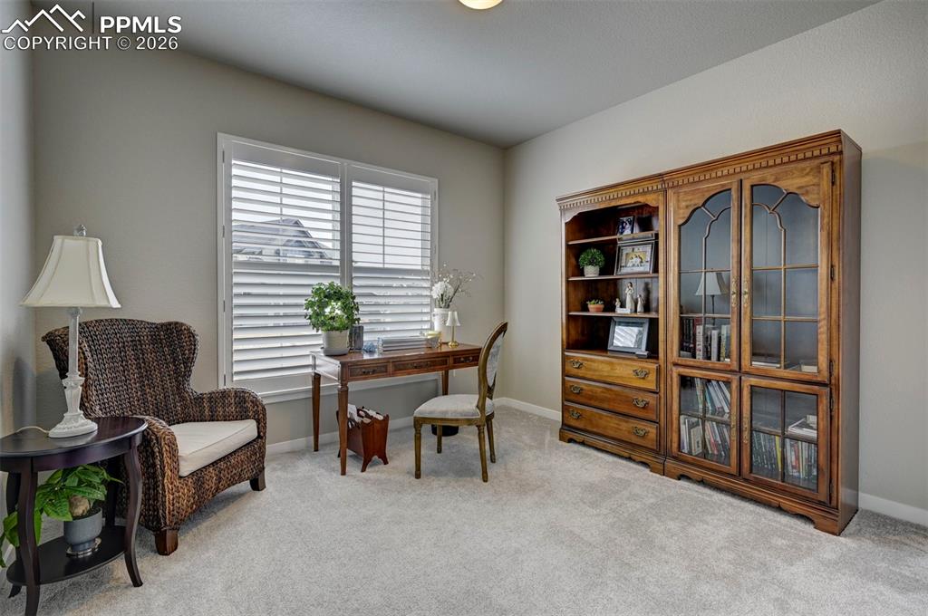Image 18 of 41: Home office with light carpet and baseboards