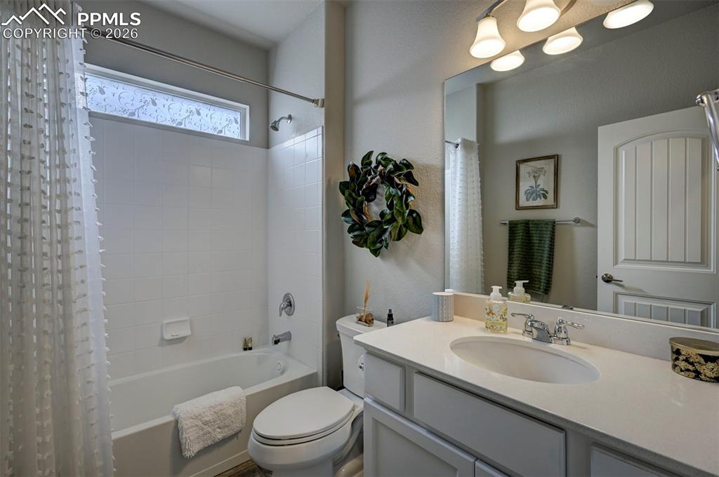 Image 23 of 41: Full bath with vanity and shower / tub combo with curtain