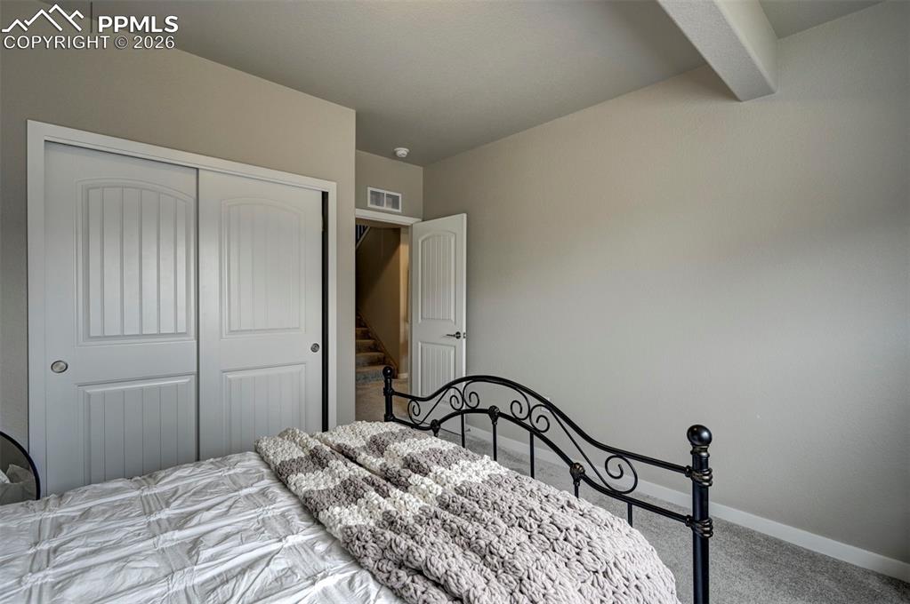 Image 26 of 41: Bedroom with carpet and a closet