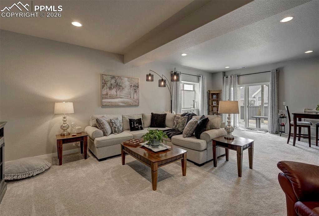 Image 31 of 41: Living room featuring light carpet, recessed lighting, and beam ceiling