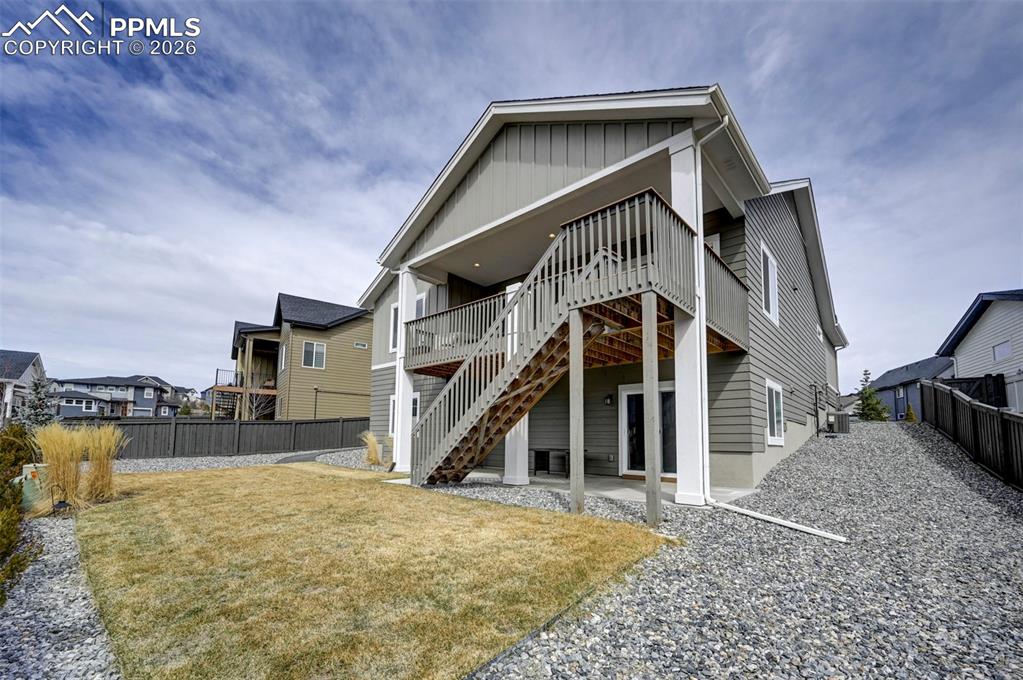 Image 34 of 41: Back of house with a patio area, board and batten siding, a fenced backyard