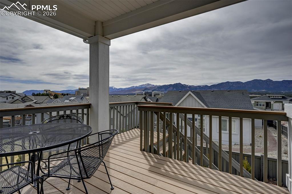Image 41 of 41: Deck featuring outdoor dining space, a residential view, and a mountain vie