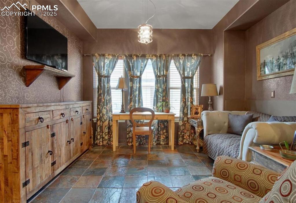Image 16 of 42: Sitting room with stone tile flooring