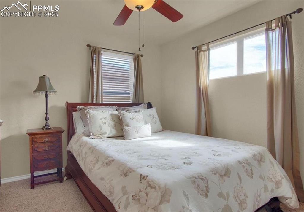 Image 19 of 42: Bedroom featuring baseboards, ceiling fan, and light carpet
