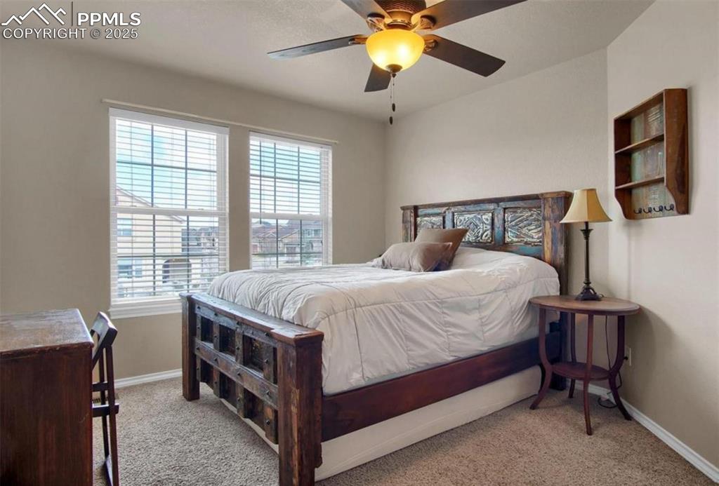 Image 20 of 42: Bedroom with carpet floors, baseboards, and ceiling fan