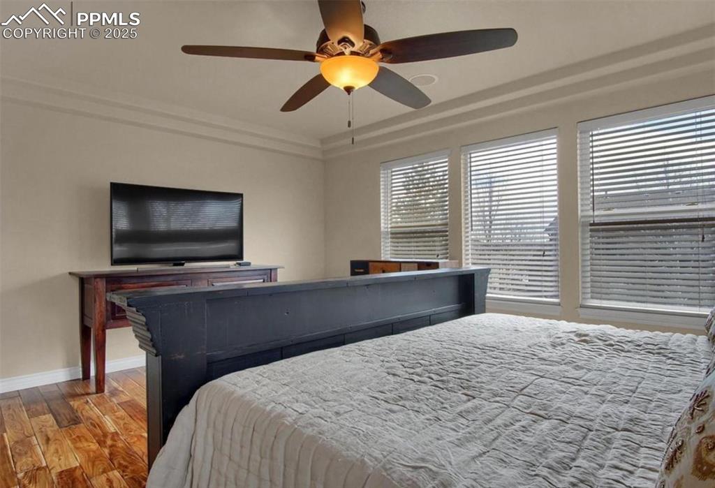 Image 24 of 42: Bedroom featuring baseboards, ceiling fan, and wood finished floors