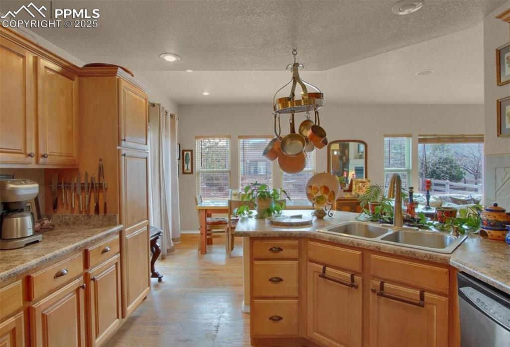 Image 6 of 42: Kitchen featuring a sink, plenty of natural light, stainless steel dishwash
