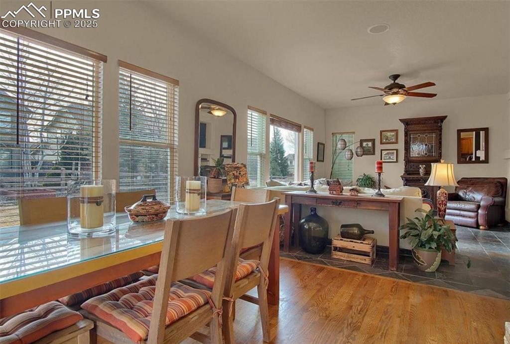 Image 8 of 42: Dining space with a ceiling fan and wood finished floors