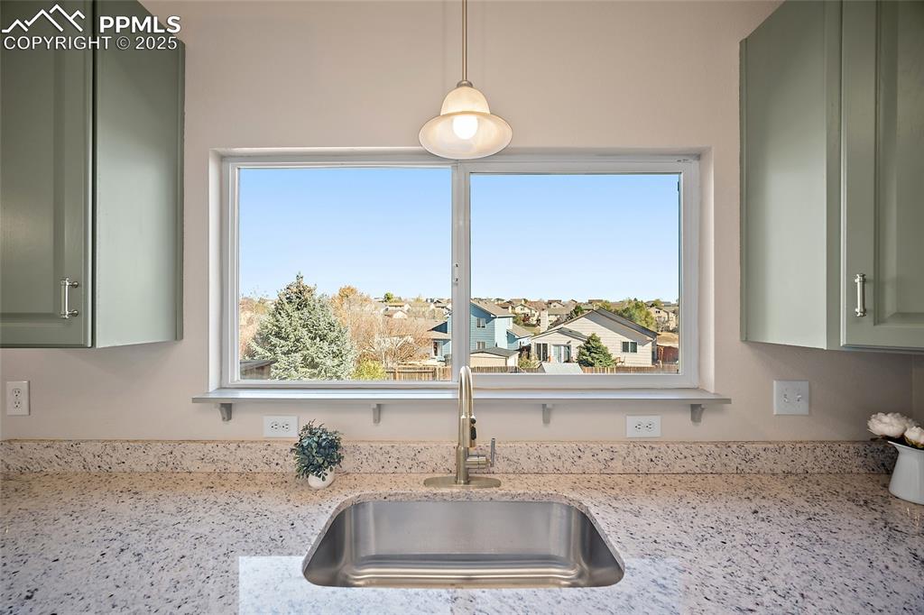 Image 11 of 45: View of large backyard from kitchen window