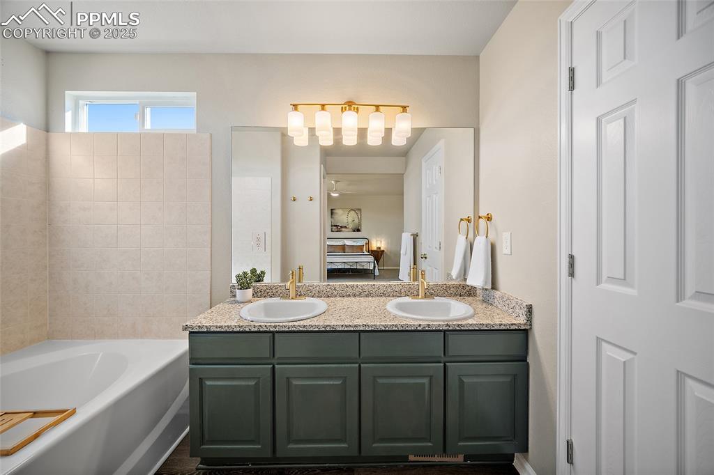 Image 19 of 45: Primary bathroom double vanity with new granite counter top