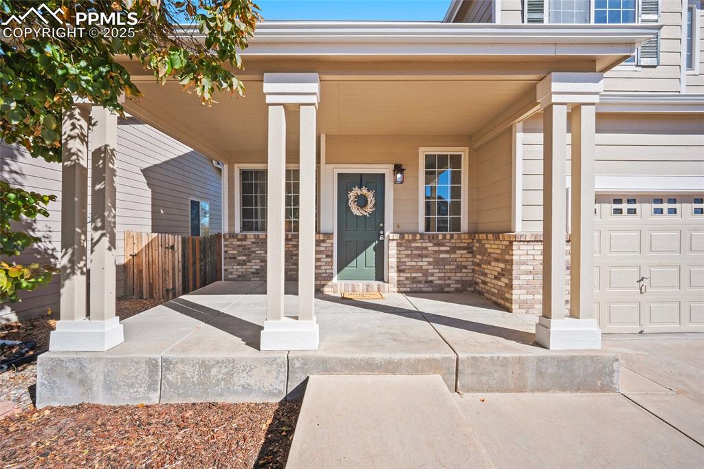 Image 2 of 45: Entry of home with covered front patio entry