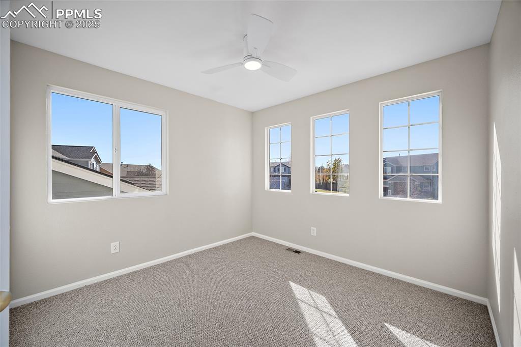 Image 24 of 45: Guest bedroom with generous amount of windows and natural light