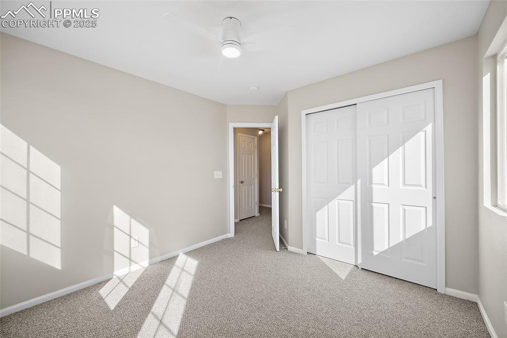 Image 25 of 45: Alternate view of guest bedroom with entry to hall