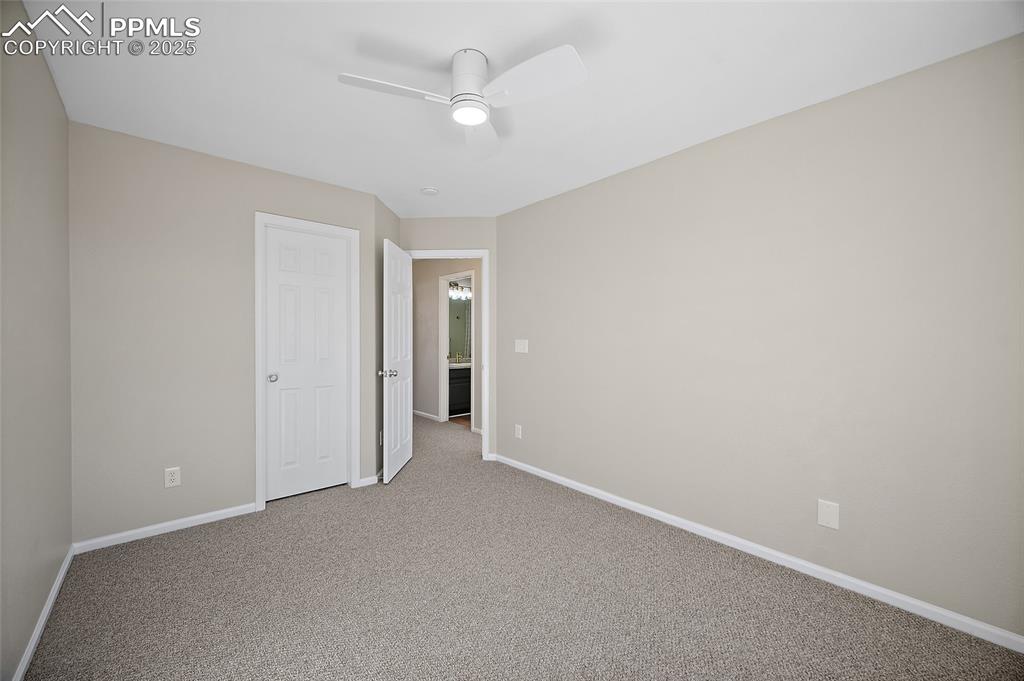 Image 27 of 45: Alternate view of guest bedroom with entry to the hall