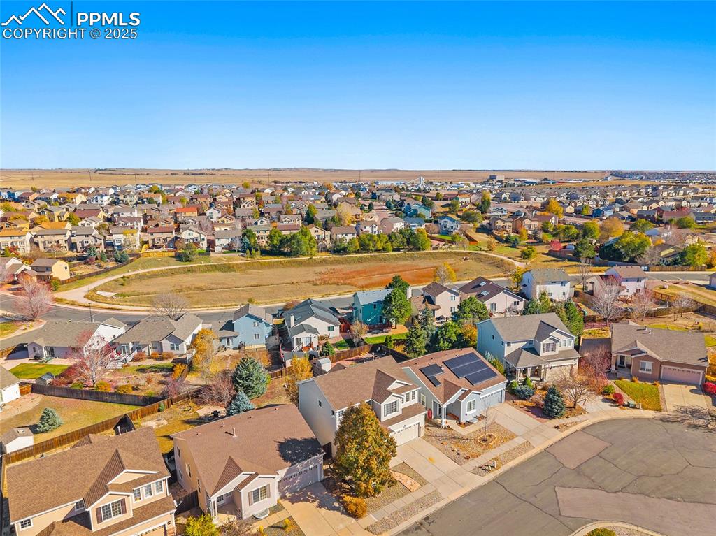 Image 39 of 45: Aerial view of the front of the home including walking path loop behind hom