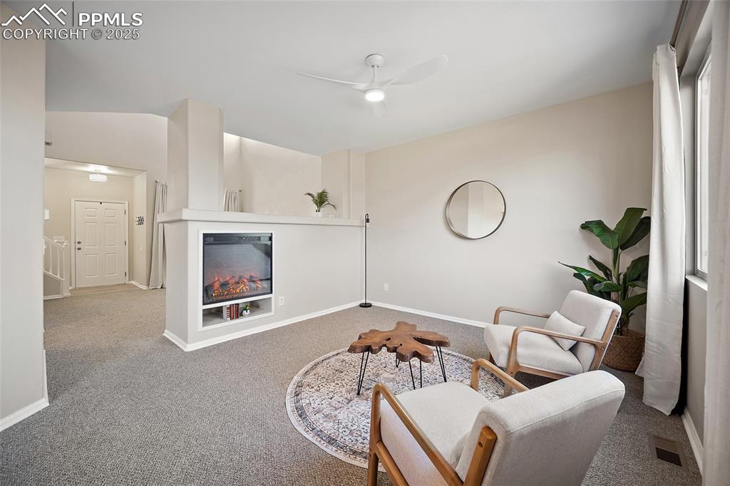 Image 5 of 45: Living room with cozy electric fire place