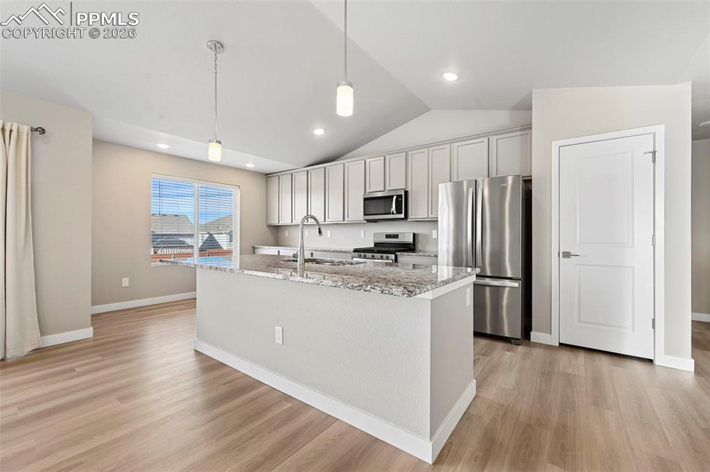 Image 11 of 42: Designer kitchen with soft gray cabinetry, island, stainless appliances 