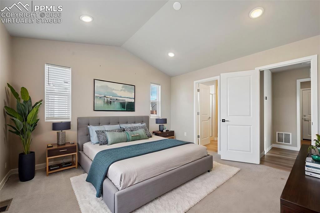 Image 16 of 42: Virtually staged primary bedroom w/ ensuite on main floor 