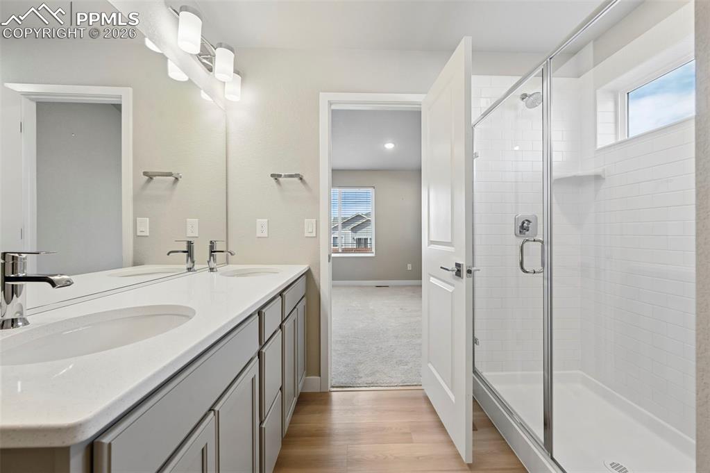 Image 18 of 42: Primary bathroom with double vanity, shower, large walk in closet 