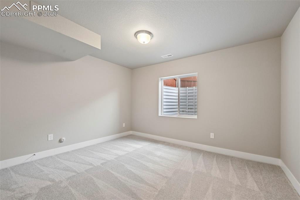 Image 31 of 42: Unstaged bedroom in basement 