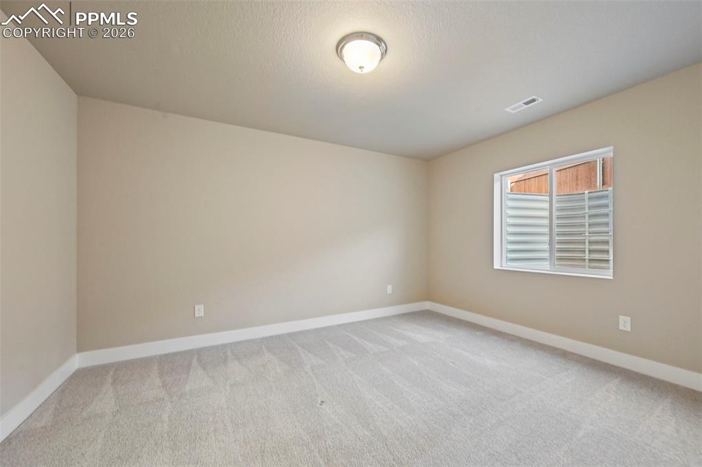 Image 33 of 42: Unstaged bedroom in basement 